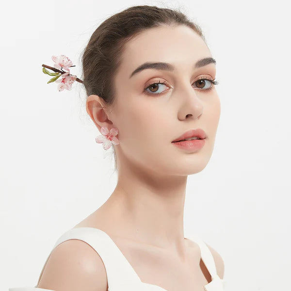 girl wearing cherry blossom earrings and hair stick
